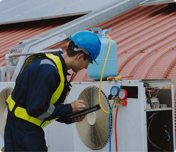 Man repairing air conditioner on roof